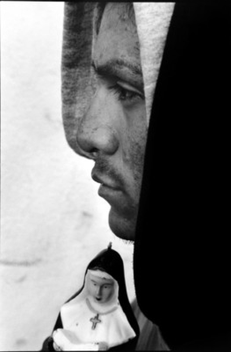 USA. San Francisco. 1999. Tenderloin. Merrill Anderson, 23, is Native American, originally from a Navajo reservation in Arizona. He has been homeless off and on for six years. He found the statuette of a nun in Chinatown. He panhandles and sells found objects to get by.