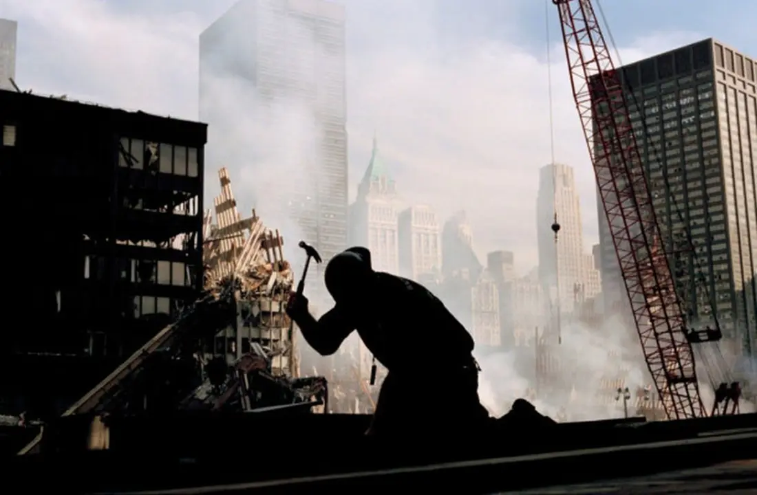 USA. New York City. September 12, 2001. A lone construction worker hammers away at the wreckage of the World Trade Center.