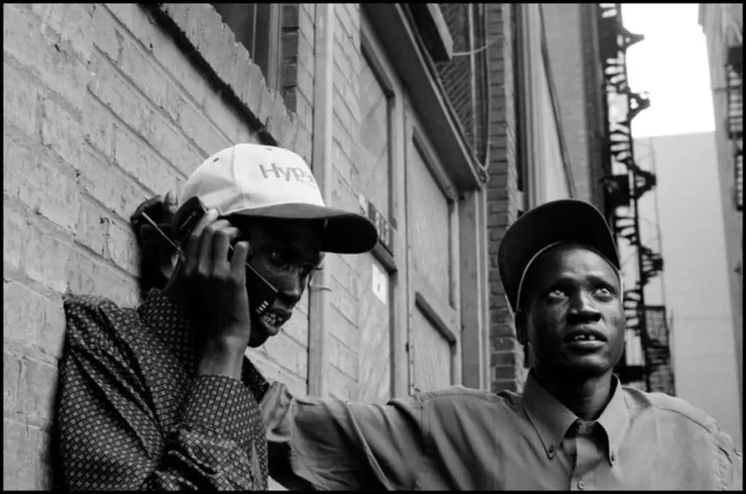 USA. Pittsburgh, Pennsylvania. August 2001. "Lost Boys" borrow a cell phone from a camera crew to call other Lost Boys.