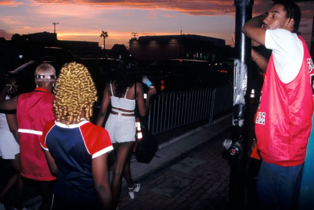 USA. Daytona Beach, Florida. 1999. As evening approaches, a man watches the parade of women.
