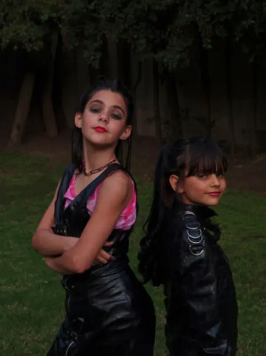 USA. Los Angeles, California. 2005. Two daughters of Yugoslavians, who came to America via London, playing dress-up in their backyard.